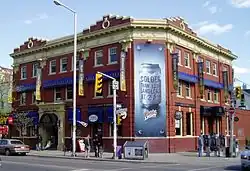The Brunswick House, a colourful three-storey red brick building with blue and yellow accents.