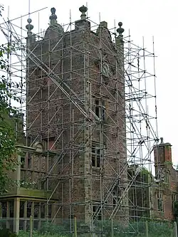 A view of the clock tower covered in scaffolding